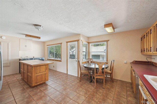 1055 N 18th St, Colorado Springs, CO 80904 - kitchen featuring tile countertops, a textured ceiling, light tile patterned flooring, and glass insert cabinets