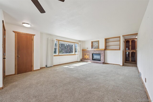 1055 N 18th St, Colorado Springs, CO 80904 - unfurnished living room featuring baseboards, carpet flooring, a brick fireplace, and ceiling fan