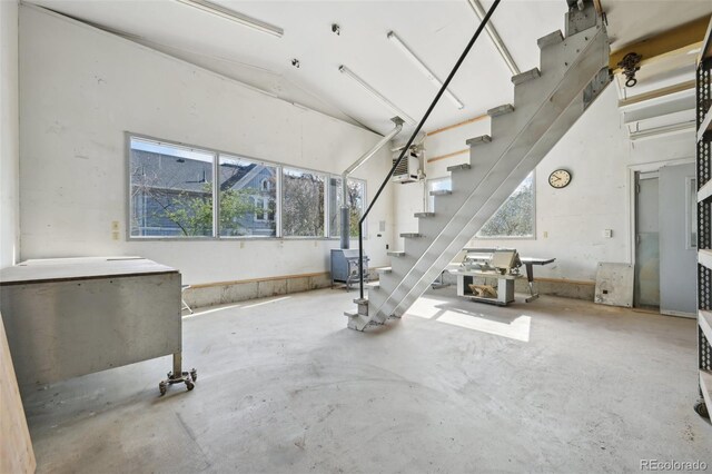 1055 N 18th St, Colorado Springs, CO 80904 - unfurnished living room with plenty of natural light, stairs, and concrete flooring