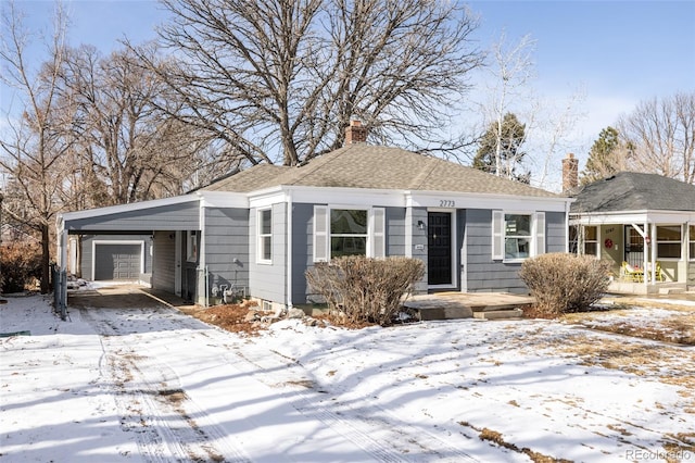 view of front of home featuring a garage and a carport