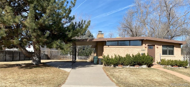 view of front of property featuring a chimney and fence