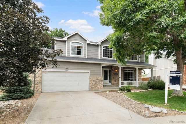 5649 W 109th Cir, Westminster, CO 80020 - traditional home featuring a porch, stone siding, concrete driveway, a garage, and a front yard