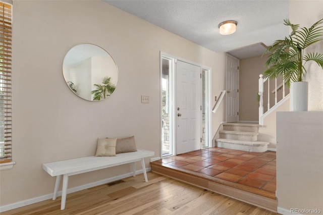 5649 W 109th Cir, Westminster, CO 80020 - foyer with stairs, healthy amount of natural light, and wood finished floors
