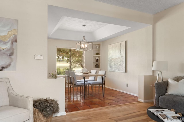 5649 W 109th Cir, Westminster, CO 80020 - tiled dining space with a chandelier and a tray ceiling