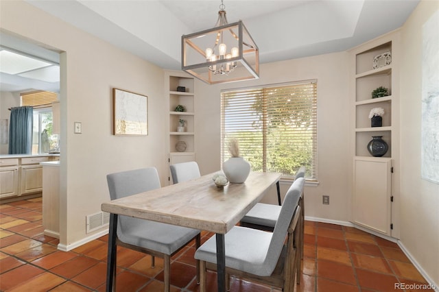 5649 W 109th Cir, Westminster, CO 80020 - dining area with a chandelier, built in shelves, and tile patterned flooring