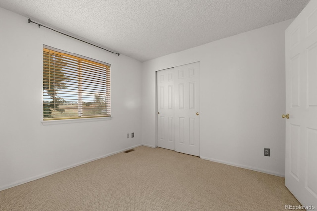 5649 W 109th Cir, Westminster, CO 80020 - unfurnished bedroom with light carpet, a textured ceiling, and a closet
