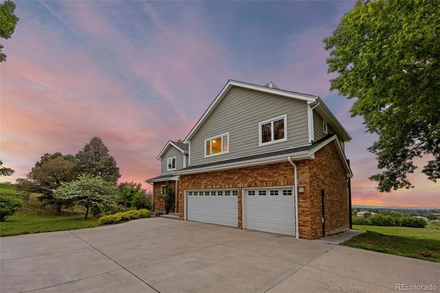 7883 S Espana Way, Centennial, CO 80016 - view of property exterior featuring concrete driveway, a garage, and brick siding
