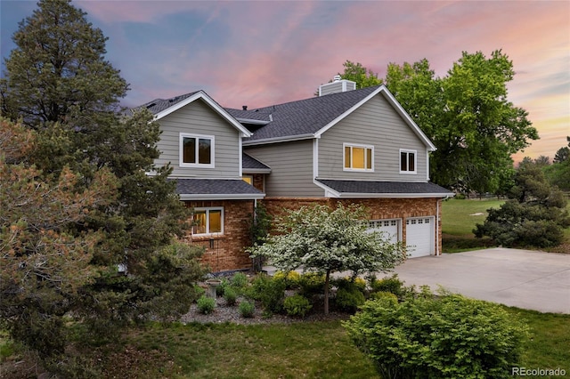 7883 S Espana Way, Centennial, CO 80016 - traditional-style house featuring a garage, a chimney, driveway, brick siding, and a shingled roof