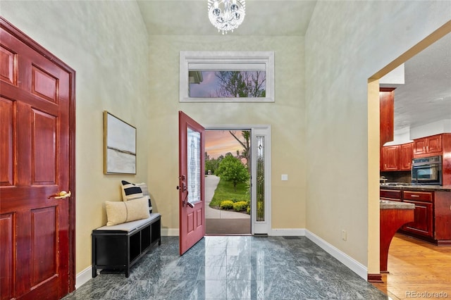 7883 S Espana Way, Centennial, CO 80016 - foyer with a high ceiling, baseboards, a chandelier, and marble finish flooring