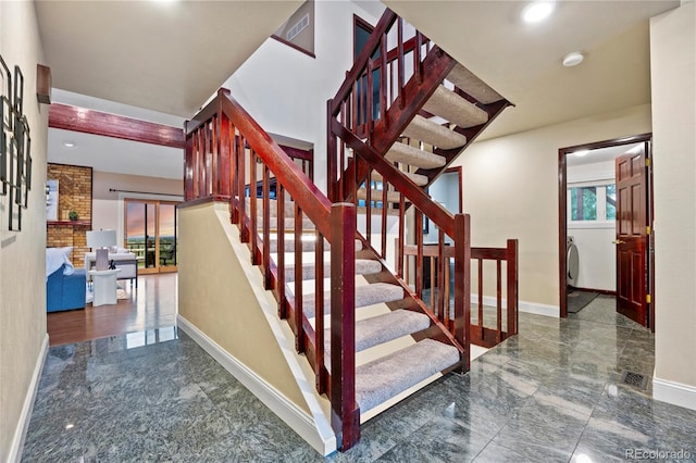 7883 S Espana Way, Centennial, CO 80016 - staircase with baseboards, marble tiled flooring, washer / dryer, and recessed lighting