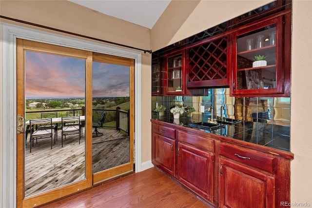 7883 S Espana Way, Centennial, CO 80016 - indoor wet bar with dark wood-style flooring, lofted ceiling, and baseboards