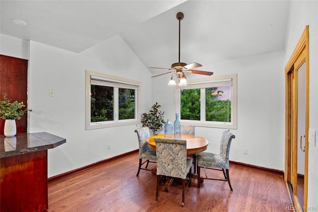 7883 S Espana Way, Centennial, CO 80016 - dining room with wood finished floors, a ceiling fan, vaulted ceiling, and baseboards