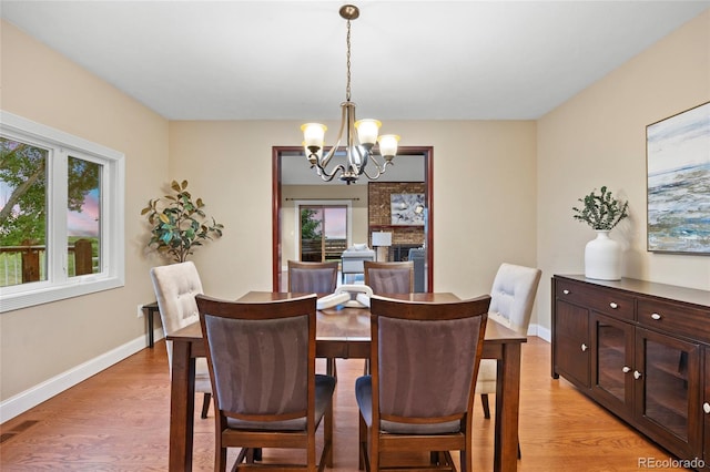 7883 S Espana Way, Centennial, CO 80016 - dining area featuring a chandelier, light wood-style flooring, and baseboards