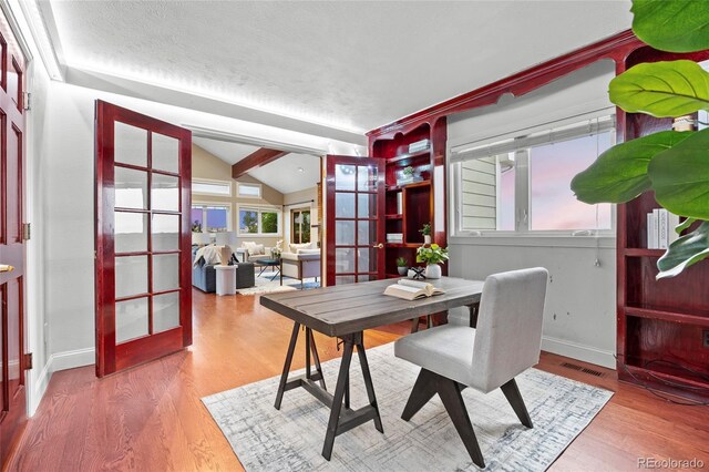 7883 S Espana Way, Centennial, CO 80016 - dining room with french doors, lofted ceiling, wood finished floors, and baseboards