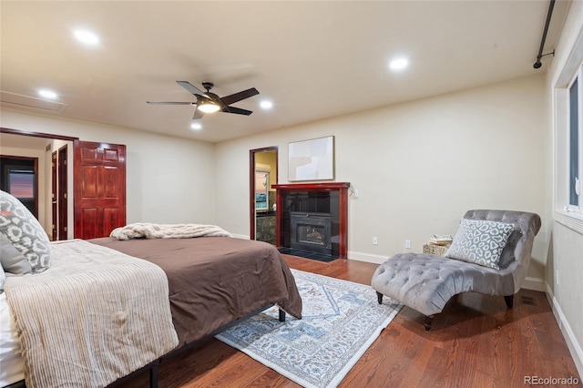 7883 S Espana Way, Centennial, CO 80016 - bedroom with wood finished floors, baseboards, recessed lighting, a fireplace with flush hearth, and a ceiling fan