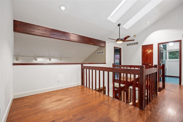 7883 S Espana Way, Centennial, CO 80016 - hall featuring a skylight, wood finished floors, baseboards, and an upstairs landing