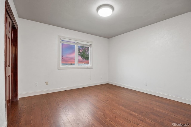 7883 S Espana Way, Centennial, CO 80016 - unfurnished bedroom featuring baseboards, dark wood-style floors, and a closet