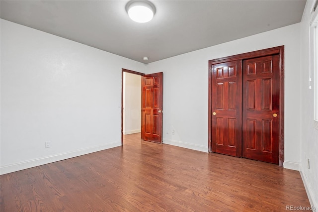 7883 S Espana Way, Centennial, CO 80016 - unfurnished bedroom with wood finished floors and baseboards