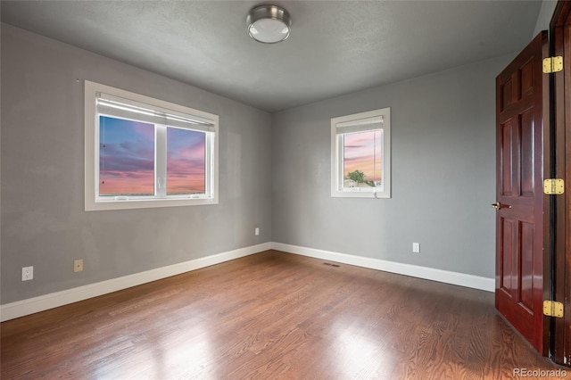 7883 S Espana Way, Centennial, CO 80016 - unfurnished room with dark wood-style floors and baseboards
