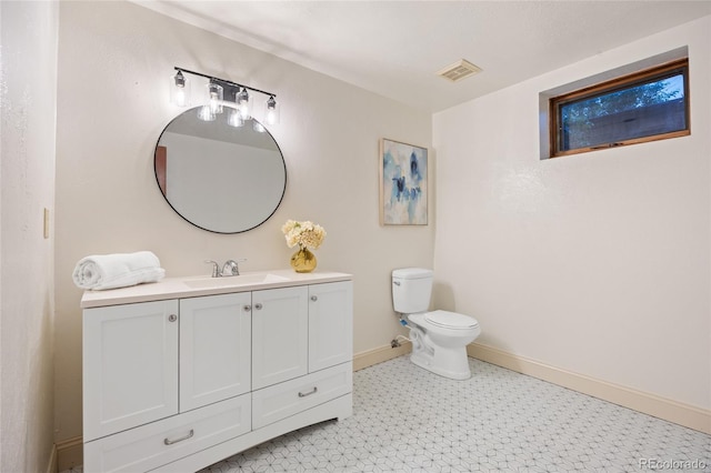 7883 S Espana Way, Centennial, CO 80016 - bathroom featuring vanity, tile patterned floors, toilet, and baseboards