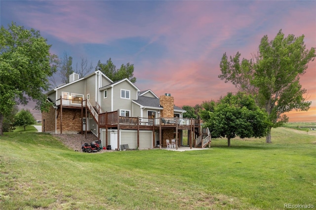 7883 S Espana Way, Centennial, CO 80016 - back of house at dusk with a deck, stairs, a chimney, and a lawn