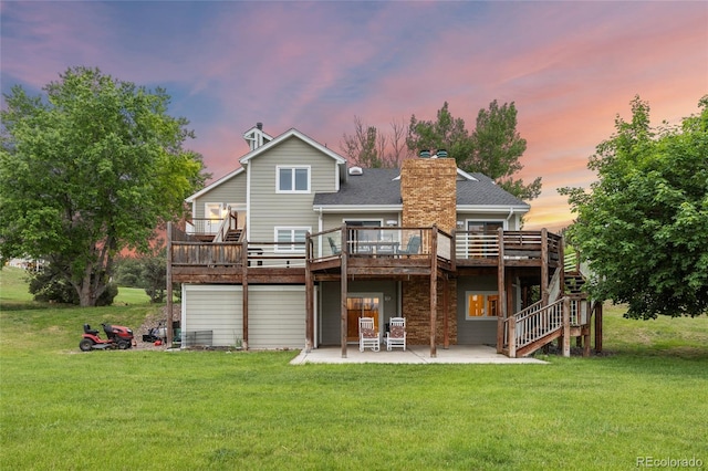 7883 S Espana Way, Centennial, CO 80016 - back of property featuring a wooden deck, a patio area, and a lawn