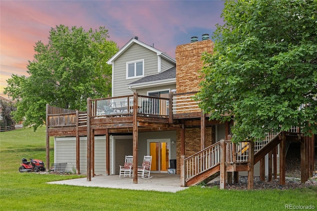 7883 S Espana Way, Centennial, CO 80016 - back of house at dusk featuring a patio, a lawn, a wooden deck, a chimney, and stairs