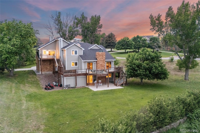 7883 S Espana Way, Centennial, CO 80016 - back of house featuring stairs, a patio, a deck, a lawn, and an attached garage