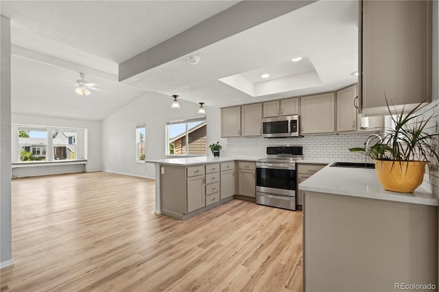 381 Mountain Cloud Cir, Highlands Ranch, CO 80126 - kitchen featuring stainless steel appliances, gray cabinets, a peninsula, light wood-type flooring, and decorative backsplash