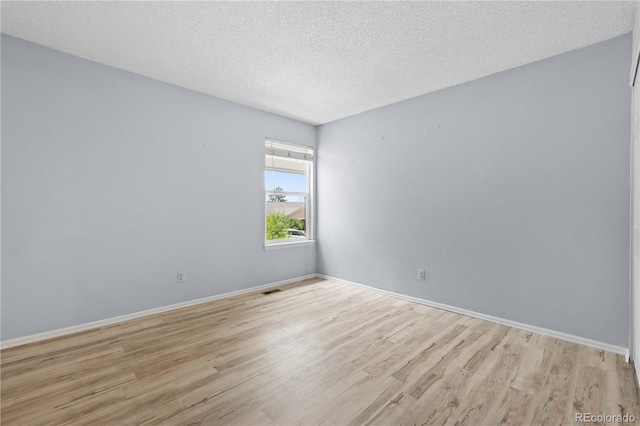 381 Mountain Cloud Cir, Highlands Ranch, CO 80126 - empty room with light wood-type flooring, baseboards, and a textured ceiling