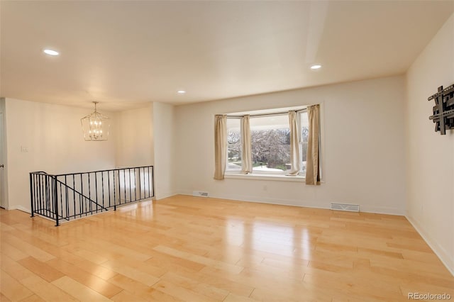 3785 S Benton Way, Denver, CO 80235 - unfurnished room featuring a chandelier, wood finished floors, and recessed lighting