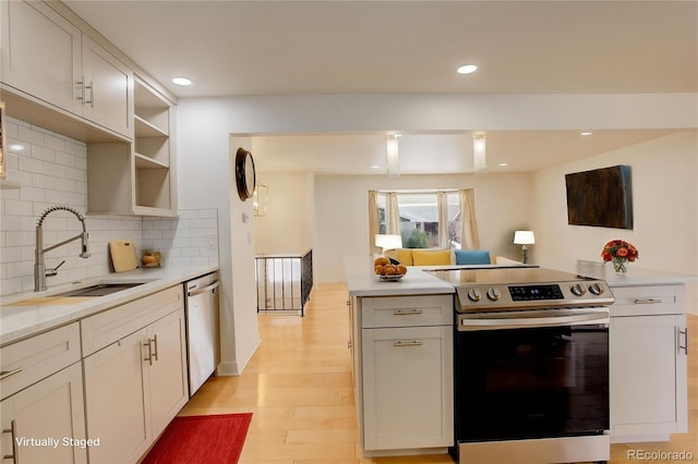 3785 S Benton Way, Denver, CO 80235 - kitchen with appliances with stainless steel finishes, light countertops, decorative backsplash, light wood-style floors, and recessed lighting
