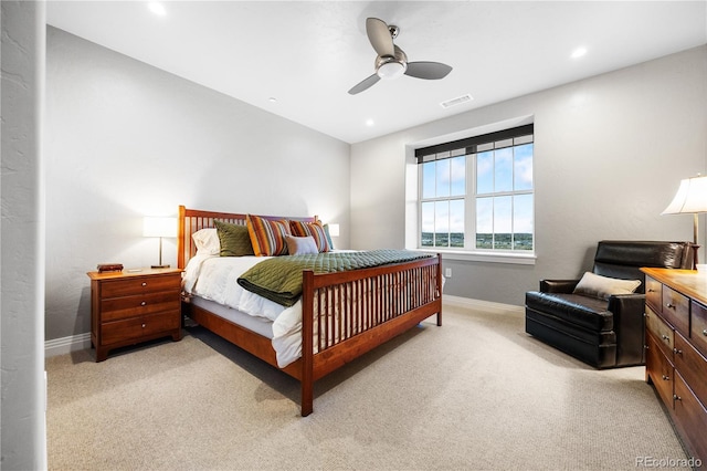 bedroom featuring a ceiling fan, baseboards, visible vents, and light carpet