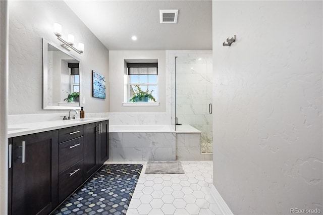full bathroom featuring visible vents, a garden tub, vanity, tile patterned floors, and a marble finish shower
