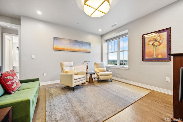 sitting room featuring baseboards, recessed lighting, wood finished floors, and visible vents