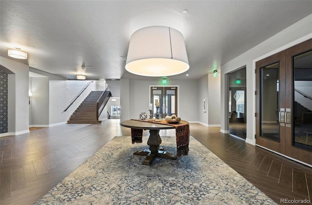 rec room with french doors and baseboards