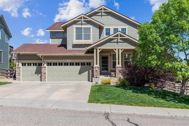10448 Kicking Horse Dr, Littleton, CO 80125 - craftsman house featuring driveway, a porch, roof with shingles, stone siding, and a garage