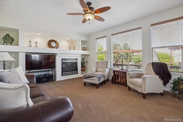 10448 Kicking Horse Dr, Littleton, CO 80125 - carpeted living room with a ceiling fan, a glass covered fireplace, and baseboards