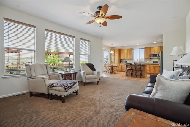 10448 Kicking Horse Dr, Littleton, CO 80125 - living room featuring a ceiling fan, baseboards, light colored carpet, and recessed lighting