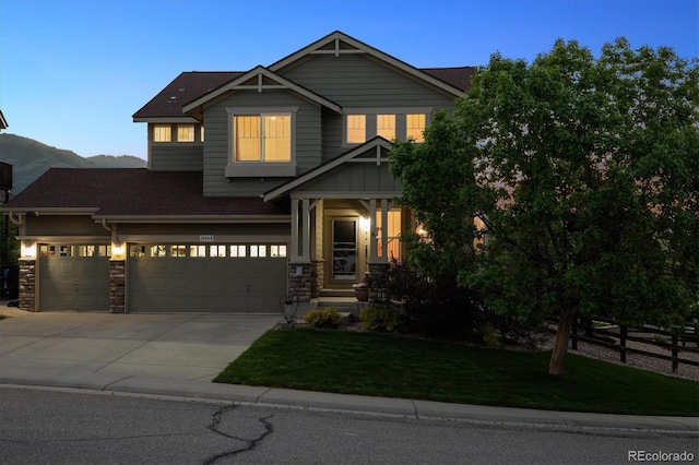 10448 Kicking Horse Dr, Littleton, CO 80125 - craftsman-style house featuring a shingled roof, driveway, a garage, and stone siding