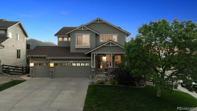 10448 Kicking Horse Dr, Littleton, CO 80125 - craftsman-style home featuring driveway, an attached garage, and stone siding