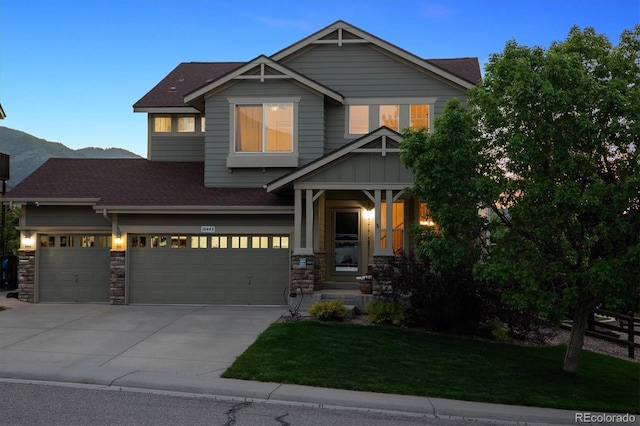 10448 Kicking Horse Dr, Littleton, CO 80125 - craftsman-style house featuring roof with shingles, a front lawn, an attached garage, driveway, and stone siding