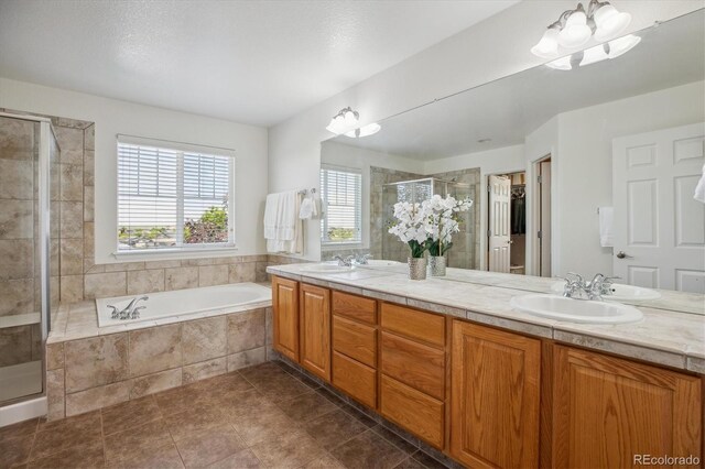 10448 Kicking Horse Dr, Littleton, CO 80125 - full bathroom featuring plenty of natural light, a shower stall, double vanity, and a bath