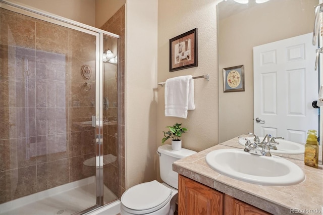 10448 Kicking Horse Dr, Littleton, CO 80125 - bathroom featuring vanity, toilet, and a shower stall
