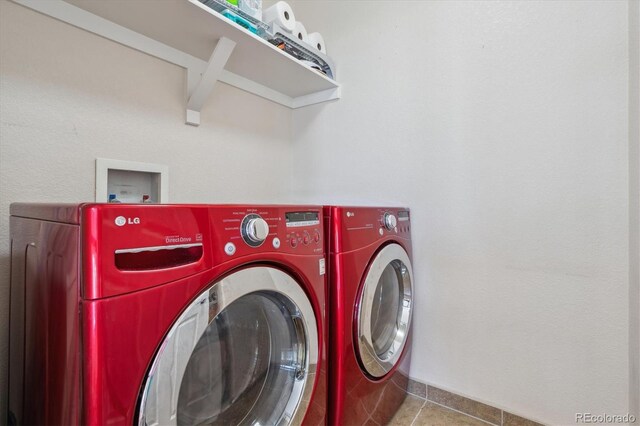 10448 Kicking Horse Dr, Littleton, CO 80125 - laundry area with washing machine and clothes dryer and tile patterned floors