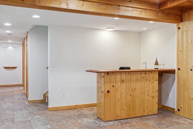 10448 Kicking Horse Dr, Littleton, CO 80125 - indoor wet bar with baseboards, light stone finish floors, recessed lighting, and stairway