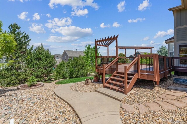 10448 Kicking Horse Dr, Littleton, CO 80125 - view of yard with a wooden deck and a pergola