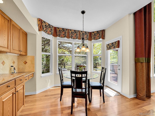 848 Huntington Pl, Highlands Ranch, CO 80126 - dining area featuring light wood finished floors, a chandelier, and baseboards
