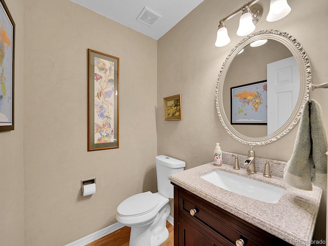 848 Huntington Pl, Highlands Ranch, CO 80126 - bathroom featuring vanity, toilet, wood finished floors, and baseboards