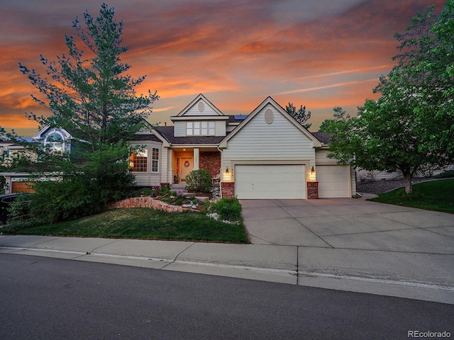 848 Huntington Pl, Highlands Ranch, CO 80126 - view of front facade featuring an attached garage, driveway, brick siding, and a front lawn